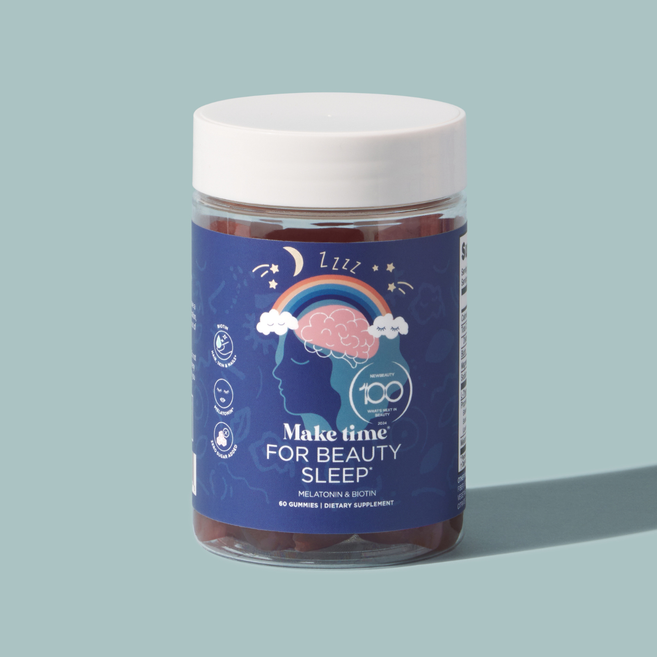A clear jar containing blue gummies labeled 'Make Time for Beauty Sleep', indicating a sleeping aid supplement.