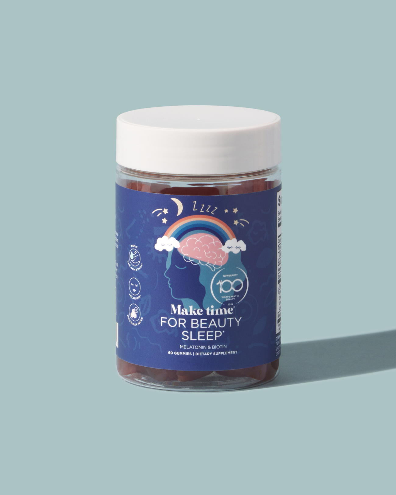 A clear jar containing blue gummies labeled 'Make Time for Beauty Sleep', indicating a sleeping aid supplement.
