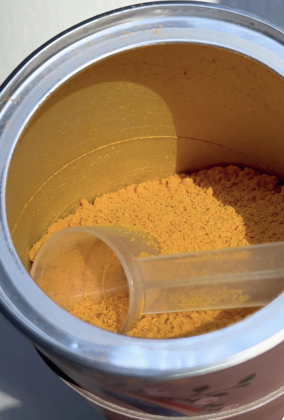 Container of yellow powder MTW BBB Powder with a scoop inside