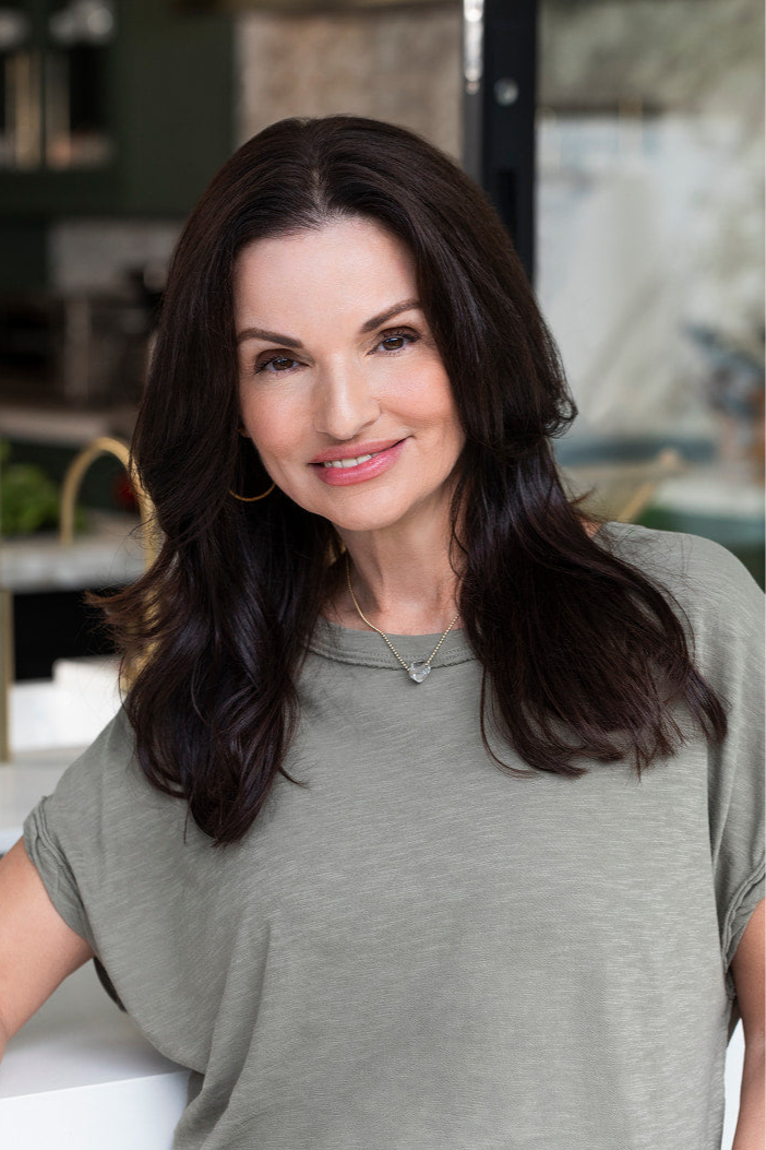 Helen Christoni wearing a gray t-shirt in an indoor setting