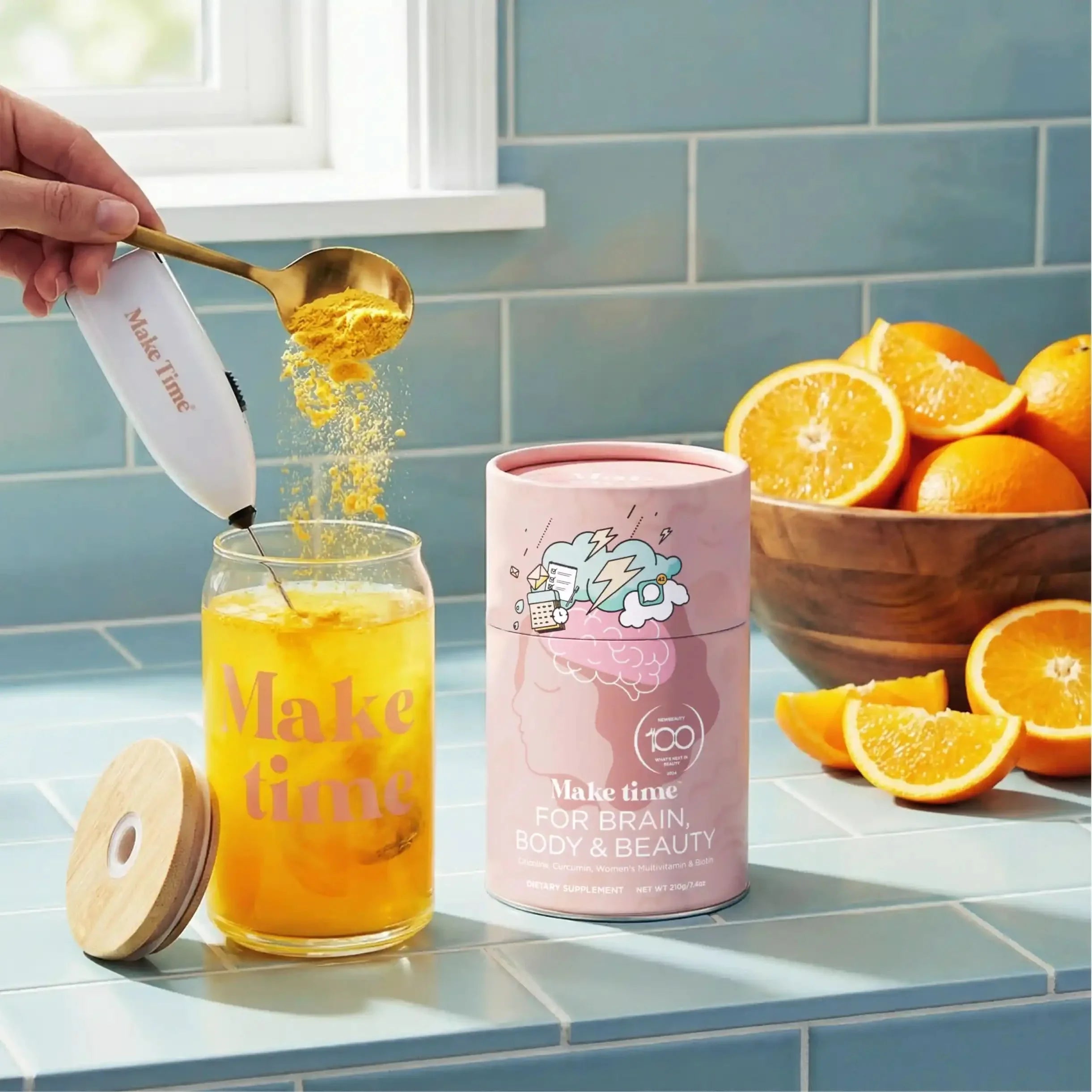 Make Time Brain, Body & Beauty powder scooped into a glass of water with oranges