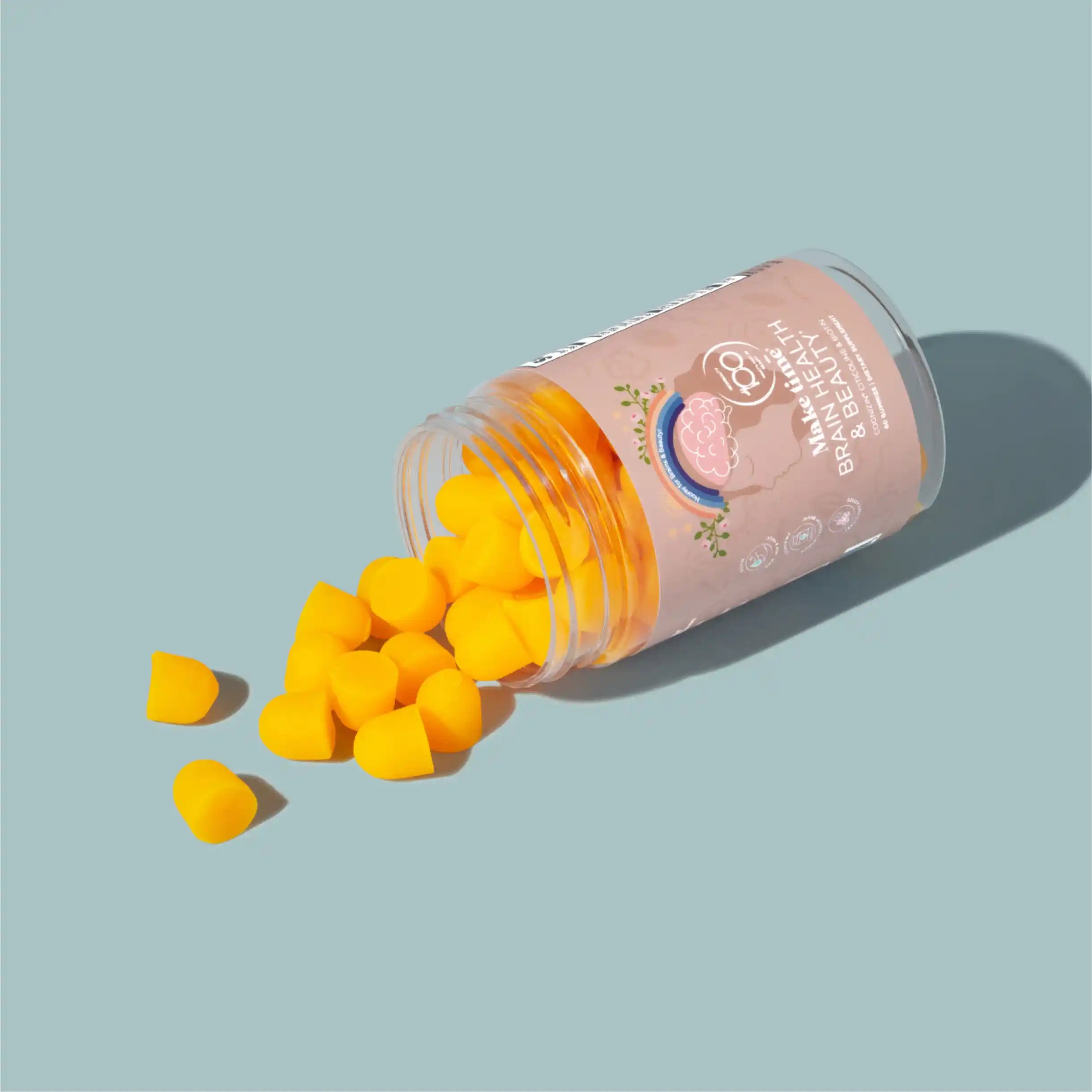 Make Time Brain & Beauty Gummy jar spilling orange gummies