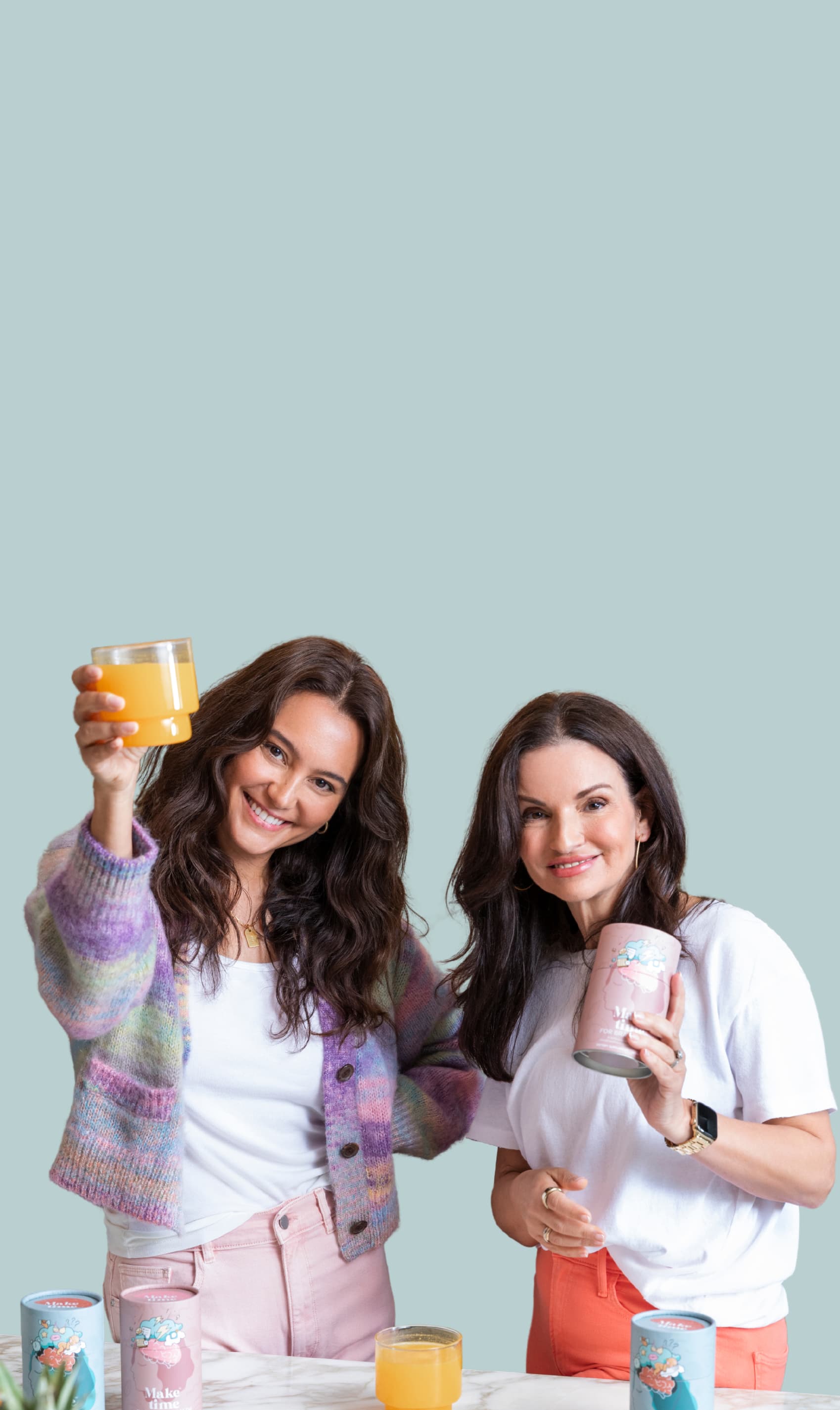 Emma Hemming Willis, and Helen Christoni holding Make Time Wellness Brain, Body, and Beauty daily all-in-one health drink against a light blue background 