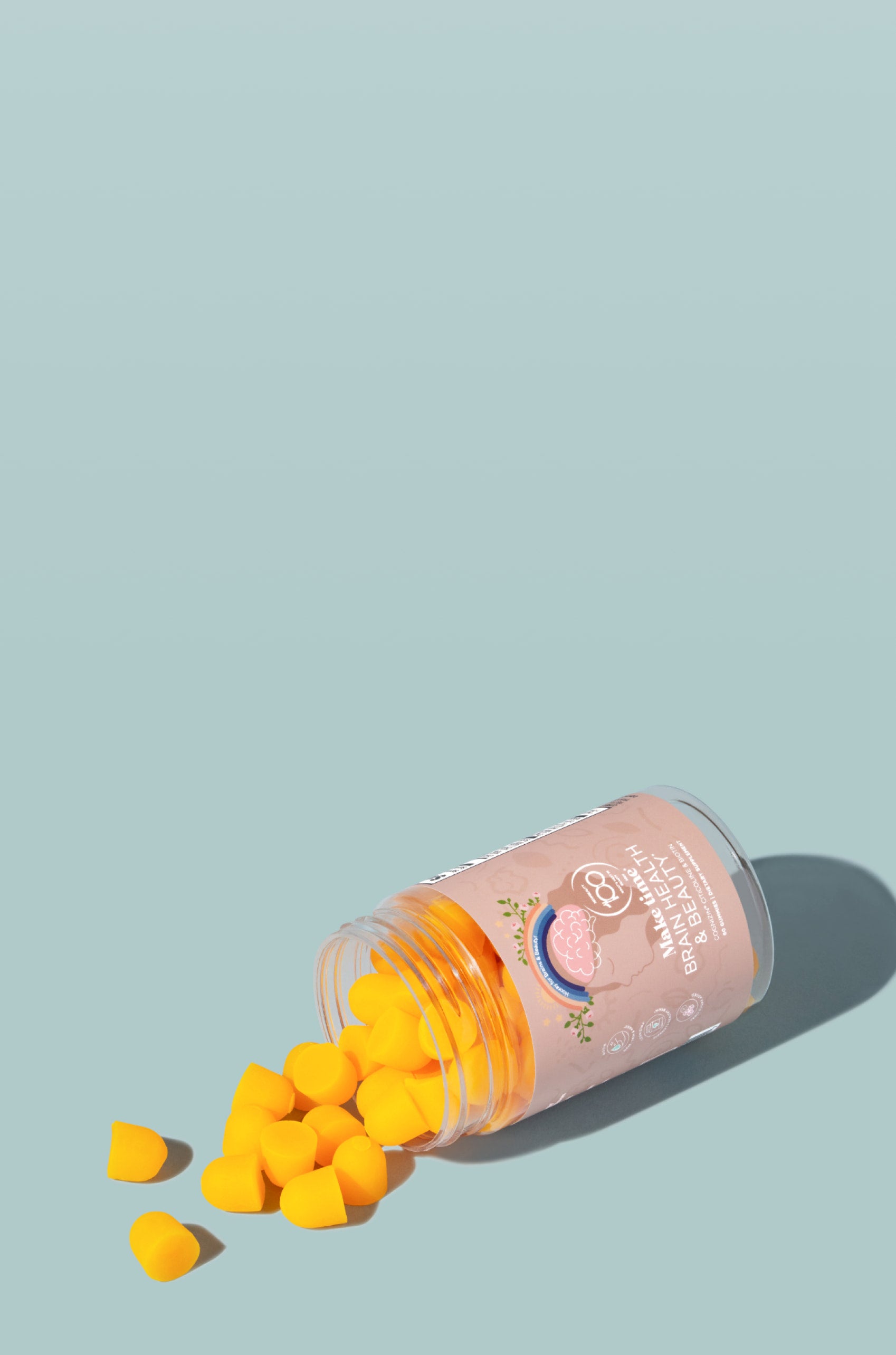 Pink bottle of Make Time for brain health and beauty gummies that are yellow-orange on a light blue background