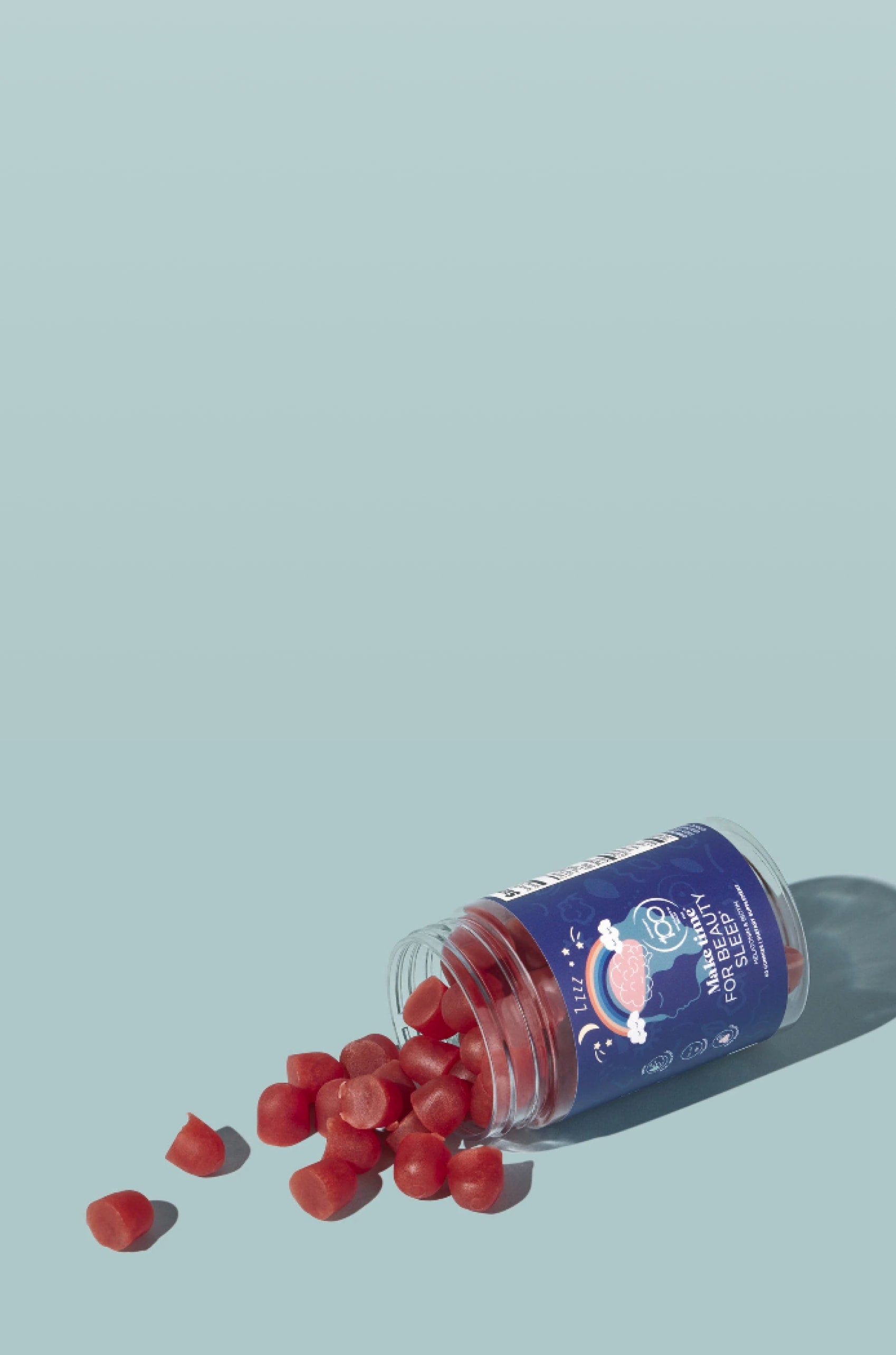 Make time for beauty sleep blue gummies spilling out on a light blue background